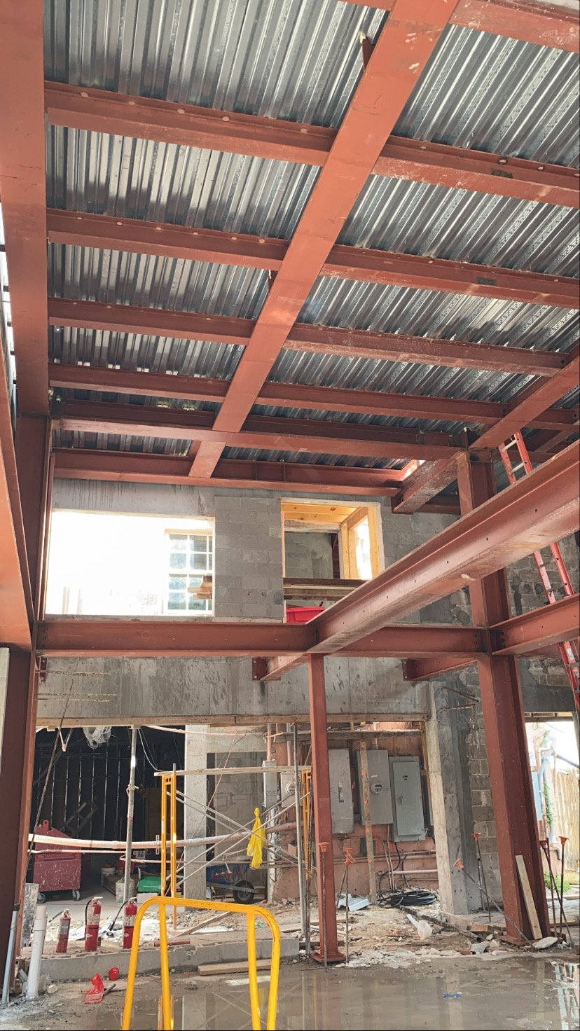 Steel frame retrofit inside concrete building